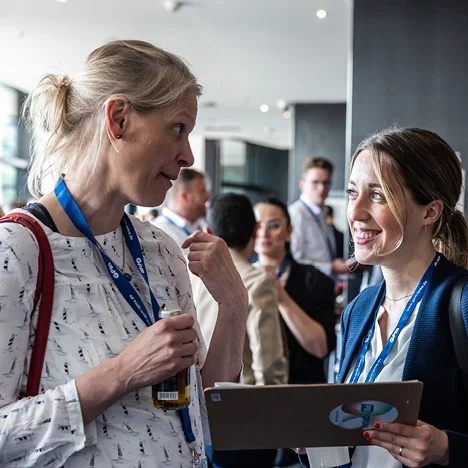 Two women talking at an event